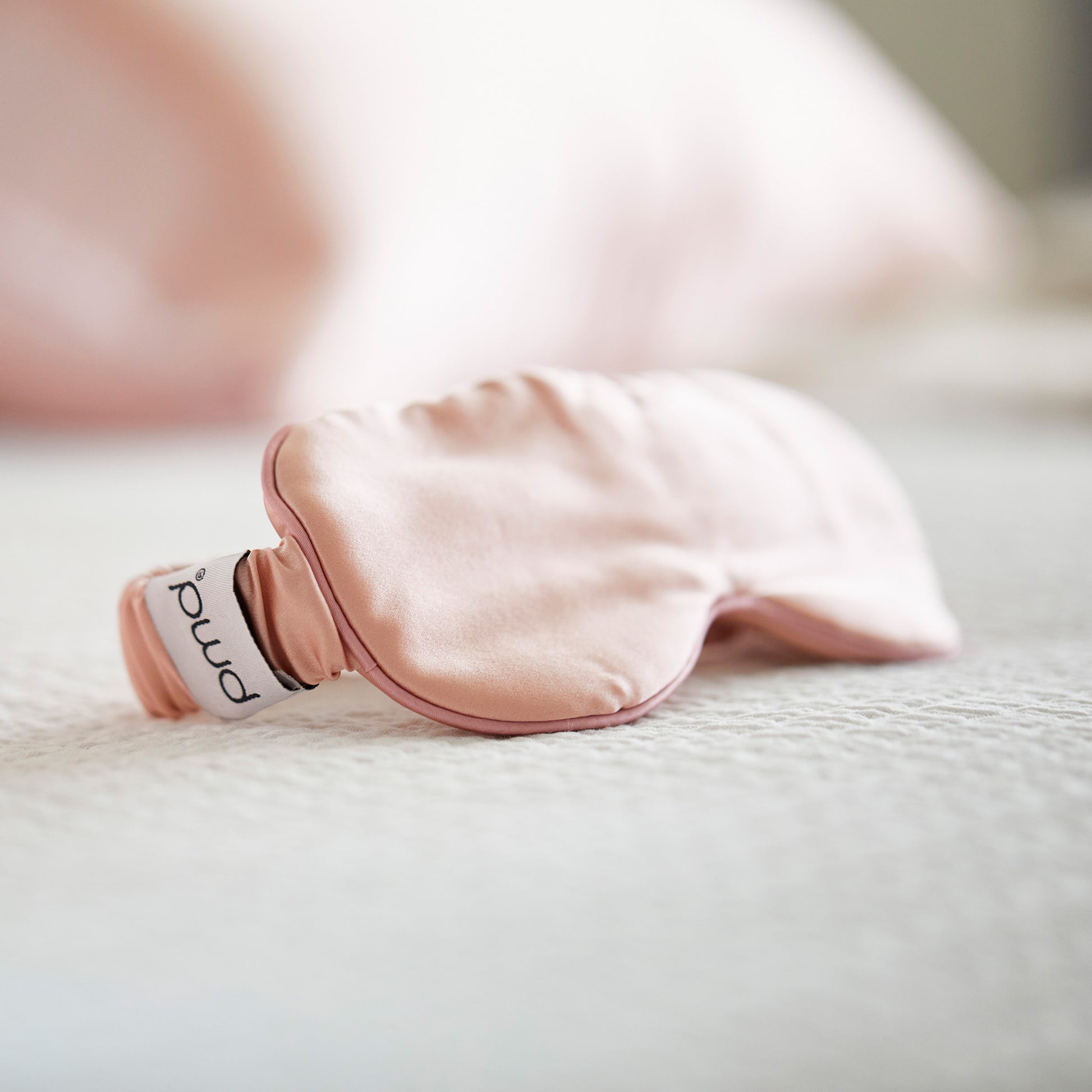 Side image of Silversilk mask on bedding.